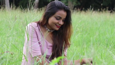 Beautiful-Indian-woman-sitting-in-tall-grass-field