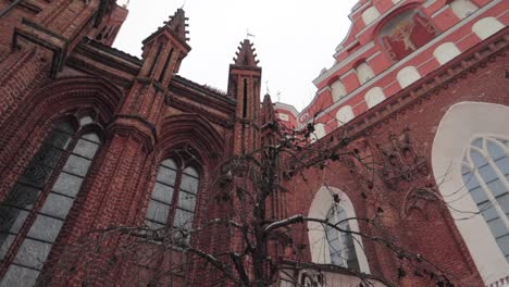 Low-angle-shot-of-a-red-brick-church-on-overcast-day-panning-right