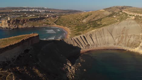 AERIAL:-Great-view-of-Clay-Cliffs-and-Ghajn-Tuffieha-Bay-in-Malta