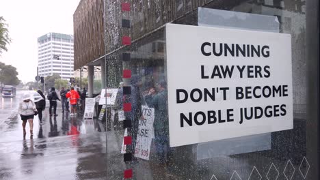Close-up-of-protesters-slogans-against-unfairness-in-courts