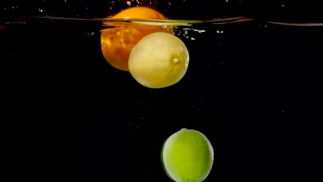 Colorful-citrus-fruits-being-dropped-into-water-in-slow-motion