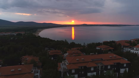Aerial,reverse,drone-shot,Red-sunset-and-luxury-pools,-in-Sozopol,Black-sea,-on-a-beautiful-sunset