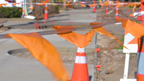 Orange-flags-and-cones-covered-the-area-the-road-being-in-construction,-windy-movement