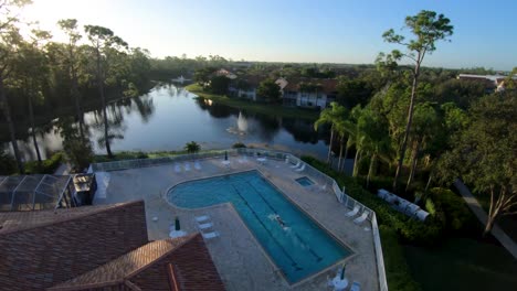 Drone-footage-of-a-male-diving-into-a-Florida-Gated-Community-pool-and-swimming
