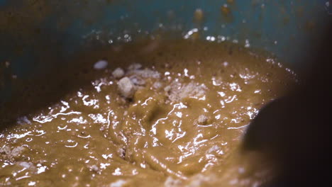 Pastry-chef-mixing-cake-batter-in-a-bowl-in-slow-motion