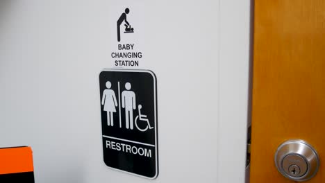Baby-changing-station-sign-outside-of-a-bathroom