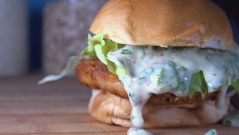 Medium-Slow-Motion-Shot-of-Fish-Cake-Sliders-with-Dripping-Sauce