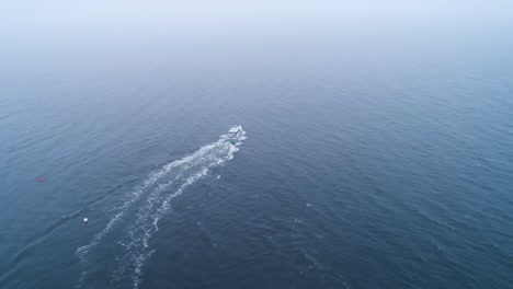 Aerial-shot-of-a-speeding-boat-near-the-harbor