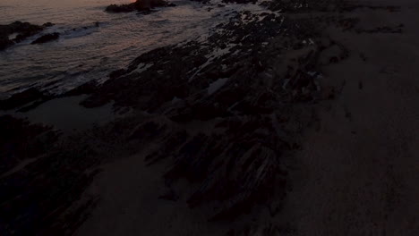 4K-Reveal-aerial-shot-of-a-beautiful-coastline-at-sunset
