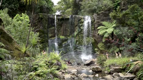 People-enjoying-Mokora-Falls,-Auckland,-New-Zealand