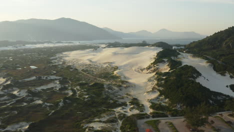 Aerial-view-of-tropical-dunes,-Praia-Da-Joaquina,-Florianopolis-city,-Santa-Catarina,-Brazil