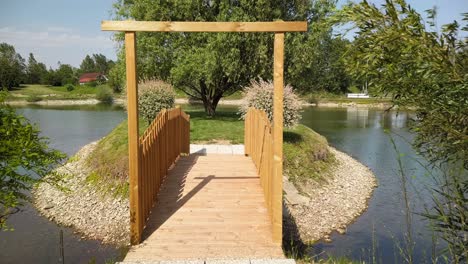 Wooden-bridge-across-pond,-garden-and-landscape-design-and-architecture