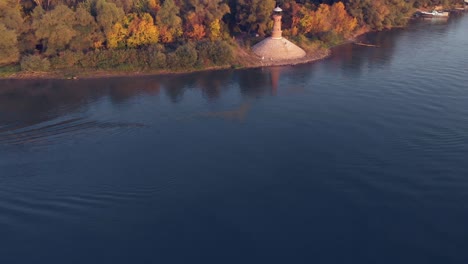 Revealing-aerial-drone-footage-of-the-lighthouse-on-the-side-of-the-Danube-river
