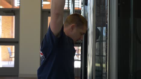 Firefighter-uses-an-exercise-machine-in-a-gym-to-stay-in-shape-and-train-for-emergency-response