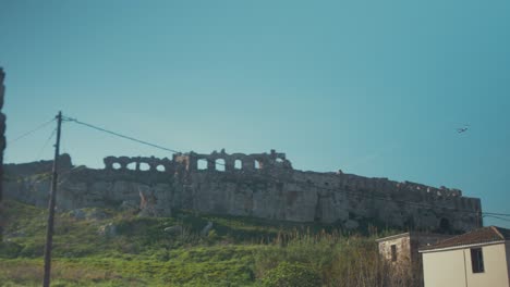 Plane-flying-over-ancient-castle-ruins-in-Mytilene