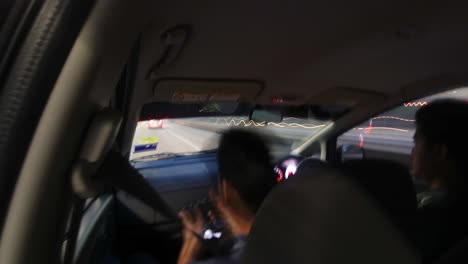 POV-shot-of-speeding-on-a-highway-in-the-evening-from-car-backseat