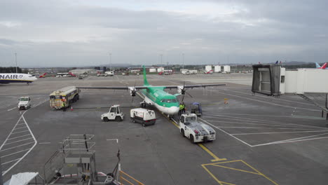 Aer-Lingus-airplane-being-loaded-with-bags-at-Edinburgh-Airport-Taxiway-while-Ryanair-airplane-pass-by-in-4K