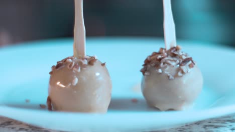 Decorating-cake-pops-with-nuts-in-a-table