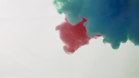 Red-and-light-blue-color-paint-ink-drops-in-water-slow-motion-100-fps