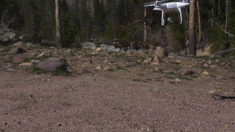 Drone-landing-on-gravel-with-river-in-background