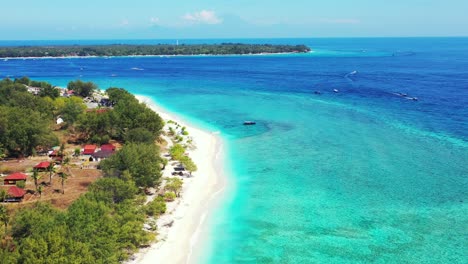 Paradise-tropical-island-with-white-sandy-exotic-beach-and-vacation-villas-built-in-front-of-calm-turquoise-sea-in-gili