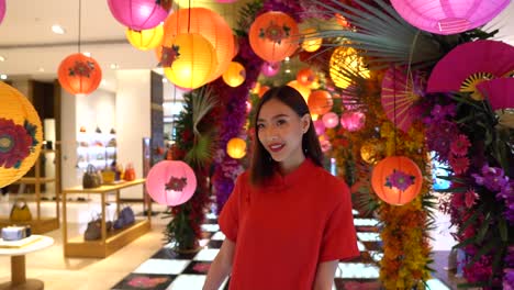 Cute-Asian-woman-is-happy-as-she-walks-through-a-home-furnishings-department-store-looking-at-Chinese-lamps---slow-motion