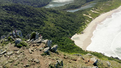 Morro-Da-Coroa-summit-circling-aerial-cinematic-shot-at-Lagoinha-Do-Leste-beach,-Florianopolis,-Santa-Catarina,-Brazil