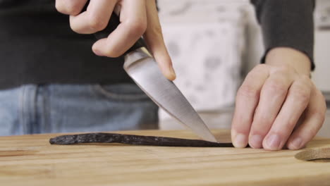 Cutting-open-a-vanilla-stick-on-a-chopping-board
