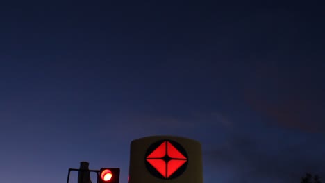 Arco-Gas-Station-Gasoline-Price-Sign-Dusk-Pan-Down-From-Sky