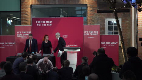 UK-December-2019:-Photographers-take-photos-as-Labour-Party-leader-Jeremy-Corbyn-and-Sir-Keir-Starmer-enter-a-press-conference-and-sit-down-at-a-table