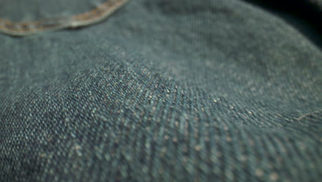 Close-up-slide-over-a-pair-of-denim-blue-jeans