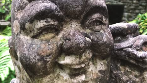 Details-Of-A-Grungy-Laughing-Buddha-Head-Sculpture---extreme-close-up