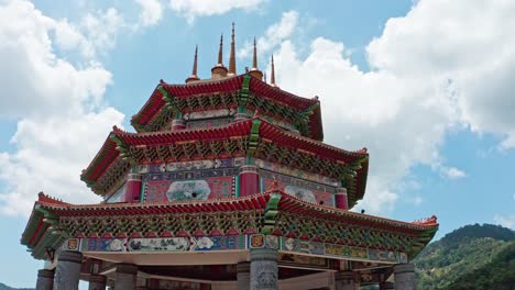 Kuan-Yin-Goddess-of-Mercy-Statue-building-roof-in-Kek-Lok-Si-Buddhist-temple,-Aerial-drone-orbit-reveal-shot