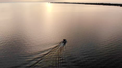 Imágenes-De-Drones-De-Un-Barco-Recreativo-Navegando-En-El-Lago-Huron-Durante-La-Puesta-De-Sol-En-Michigan