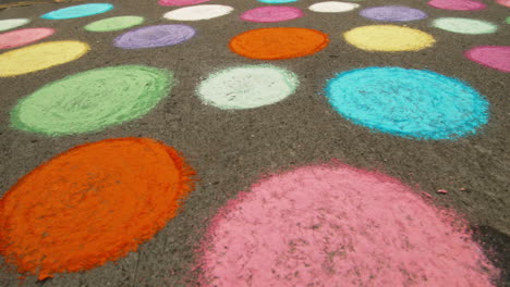 Pola-dot-sidewalk-chalk-art,-Close-Up,-Slide-Right