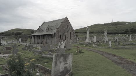 Llandudno-coastal-Tudnos-church-mountain-chapel-graveyard-aerial-low-angle-dolly-right-view
