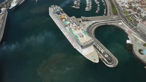 Huge-cruise-ship-docked-in-port,-travel-and-tourism-concept