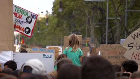 Young-child-on-shoulders-at-global-warming-environment-protest