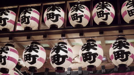 Close-up-of-traditional-japanese-paper-lanterns-with-symbols-on-it