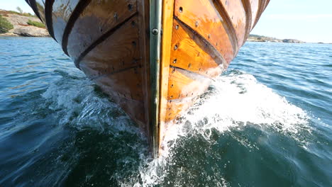 Front-of-a-wooden-Sjekte-boat-slicing-through-the-waves---slow-motion