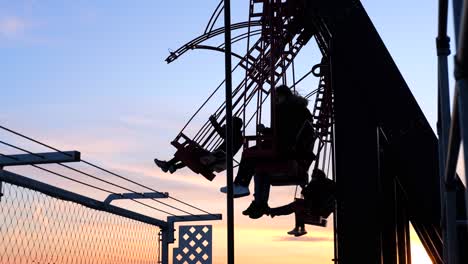 Silhouette-of-people-on-A'DAM-LOOKOUT-swing-during-sunset