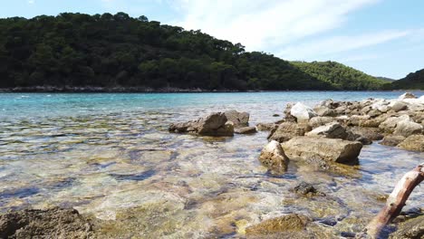 Glistening-water-on-a-rocky-beach-near-Soline-on-Mljet-Island-in-Croatia-in-the-Adriatic-Sea