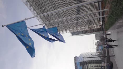 Vertical-video-of-European-flags-waving-in-the-European-quarter-in-Brussels
