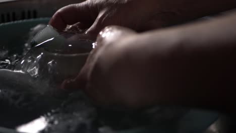 Hands-washing-up-in-kitchen-sink-close-up-shot