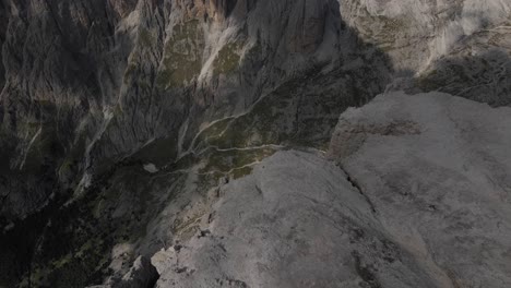 Aerial-view-on-Dolomites-in-Val-Gardena,-drone-shot-that-reveals-a-canyon-or-ravine-or-precipice