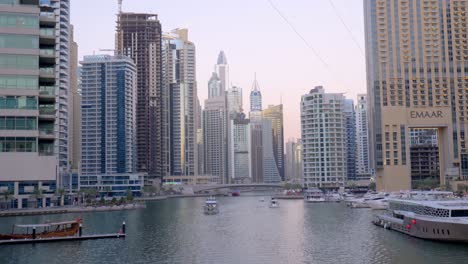 Dubai-Marina,-handheld-shot-from-a-bridge-overlooking-the-canals