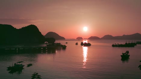 Fiery-sunset-over-the-waters-and-mountains-of-Catba-Island-in-Vietnam--aerial