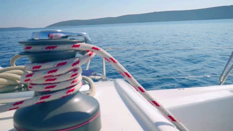 Rope-Rolled-On-A-Winch---Boat-Sailing-Over-The-Sea---close-up