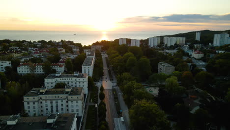 Epic-amazing-drone-shot-over-Gdynia-descend-into-an-empty-tree-lined-street-during-an-early-morning