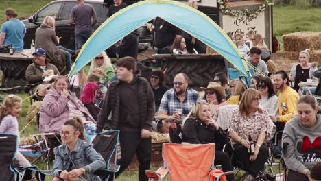 People-sitting-eat-and-drink-and-smokie-at-Rotherham-Farmfest-in-UK